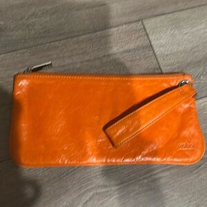 HOBO orange leather clutch wristlet wallet.